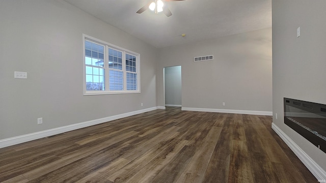 unfurnished living room featuring ceiling fan and dark hardwood / wood-style flooring