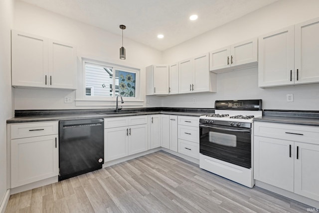 kitchen with light wood-type flooring, sink, black dishwasher, white cabinetry, and white gas stove