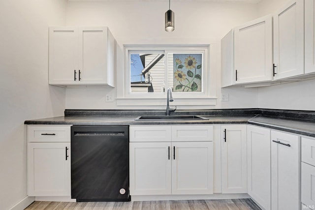 kitchen with white cabinets, black dishwasher, light hardwood / wood-style floors, and sink