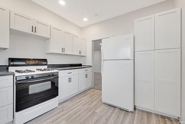 kitchen featuring white appliances, white cabinetry, and light hardwood / wood-style flooring