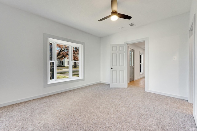 carpeted empty room with ceiling fan