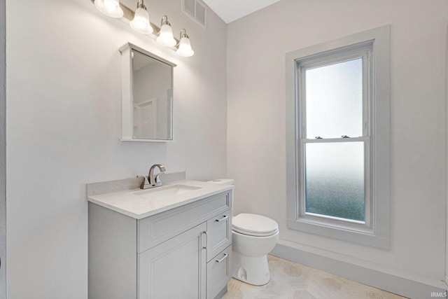 bathroom with vanity and toilet