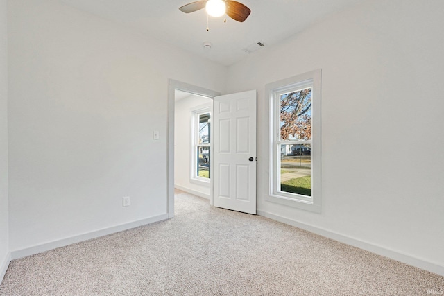 spare room with carpet flooring and ceiling fan