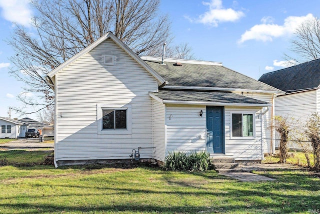 rear view of property with a yard