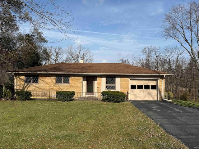 single story home featuring a garage and a front yard