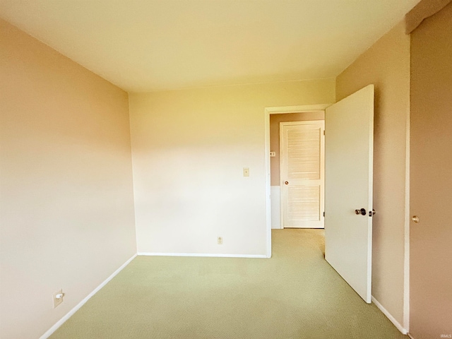 unfurnished room featuring light carpet