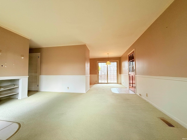 unfurnished living room featuring carpet flooring and a chandelier