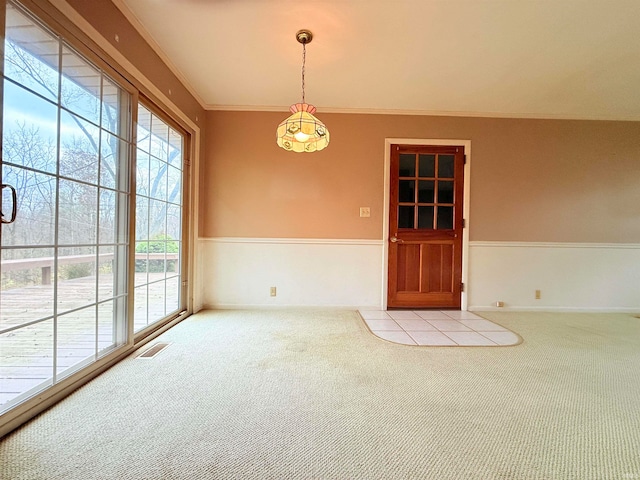 empty room featuring light colored carpet and crown molding