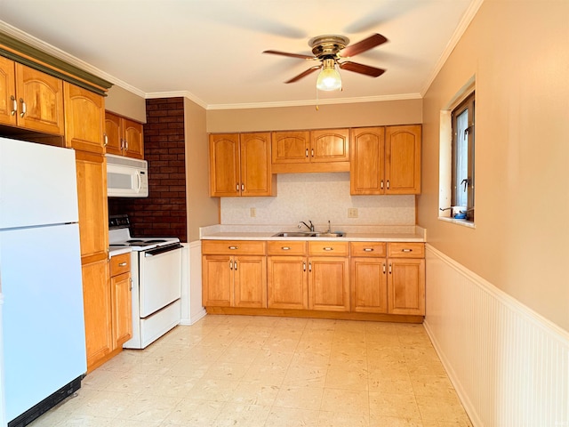 kitchen featuring white appliances, ceiling fan, crown molding, and sink