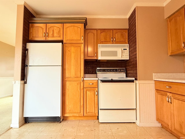 kitchen with crown molding and white appliances