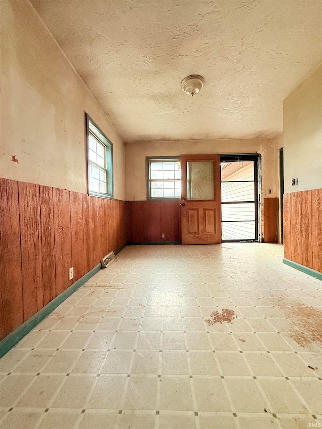 spare room with wooden walls