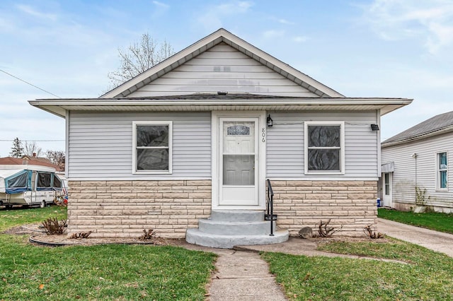 bungalow-style home with a front lawn