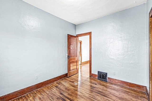 spare room featuring hardwood / wood-style floors