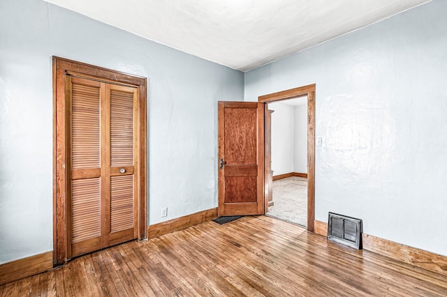 unfurnished bedroom with hardwood / wood-style flooring