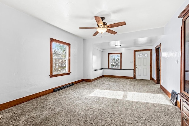 unfurnished room with ceiling fan and light colored carpet