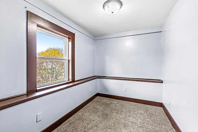 empty room featuring a healthy amount of sunlight and carpet floors