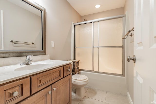 full bathroom with tile patterned flooring, vanity, toilet, and bath / shower combo with glass door