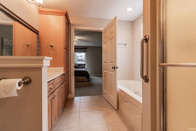 bathroom featuring tile patterned floors, vanity, and a bathing tub