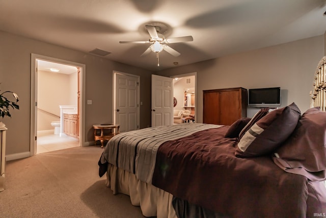 carpeted bedroom with connected bathroom and ceiling fan