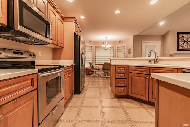 kitchen with appliances with stainless steel finishes, decorative light fixtures, an inviting chandelier, and sink