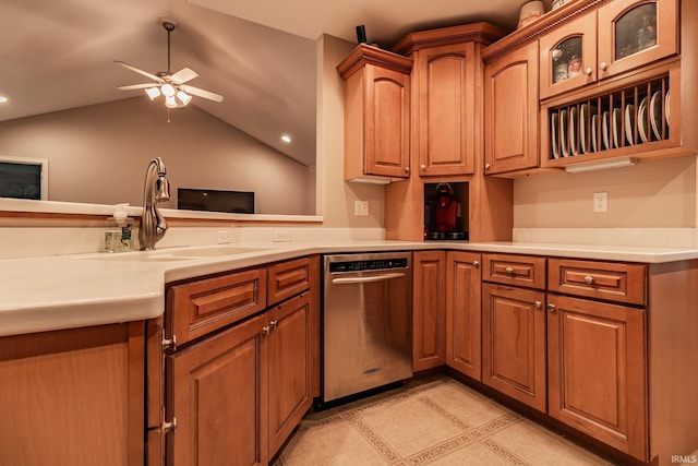 kitchen with ceiling fan, sink, stainless steel dishwasher, and lofted ceiling