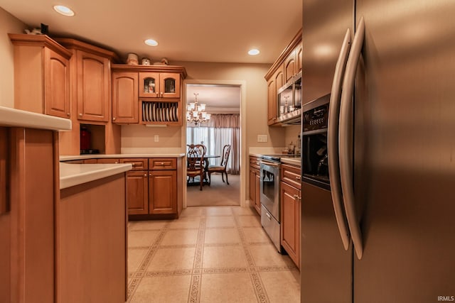 kitchen with pendant lighting, a chandelier, and appliances with stainless steel finishes