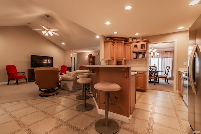 kitchen with stainless steel fridge with ice dispenser, vaulted ceiling, a kitchen bar, light carpet, and ceiling fan with notable chandelier