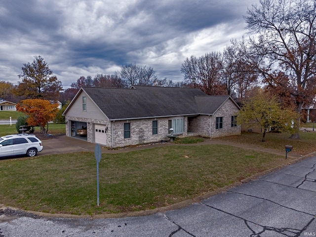 view of front of property with a garage and a front lawn