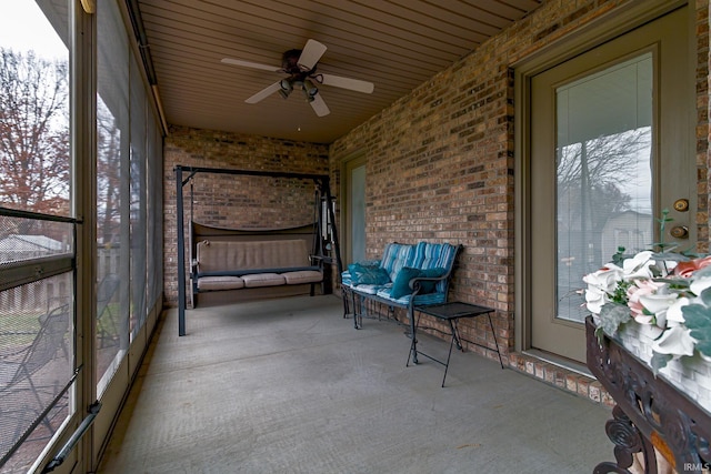 unfurnished sunroom with ceiling fan and a healthy amount of sunlight