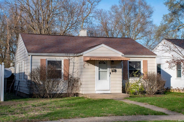 bungalow-style home with a front lawn