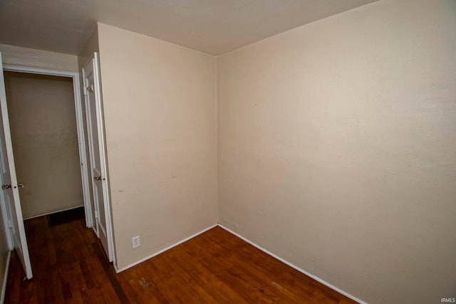 unfurnished bedroom featuring dark wood-type flooring