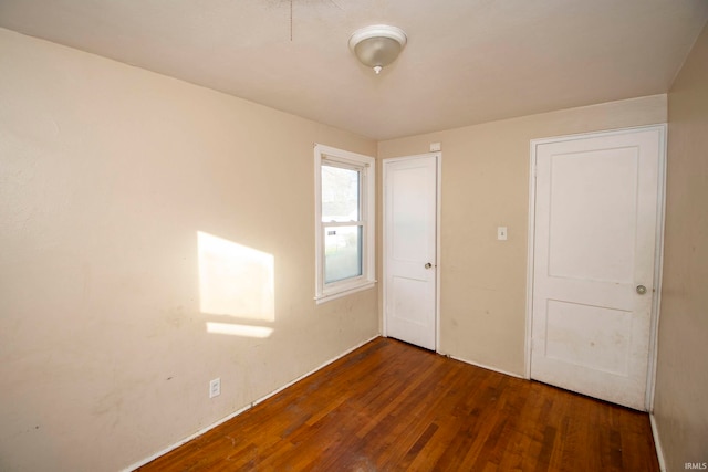 unfurnished bedroom featuring dark hardwood / wood-style floors