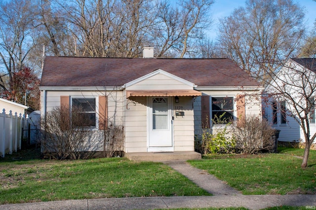 bungalow-style house with a front yard