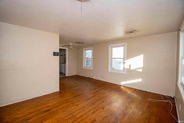 unfurnished room with ceiling fan and dark wood-type flooring