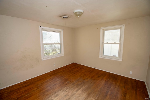 spare room featuring dark hardwood / wood-style floors