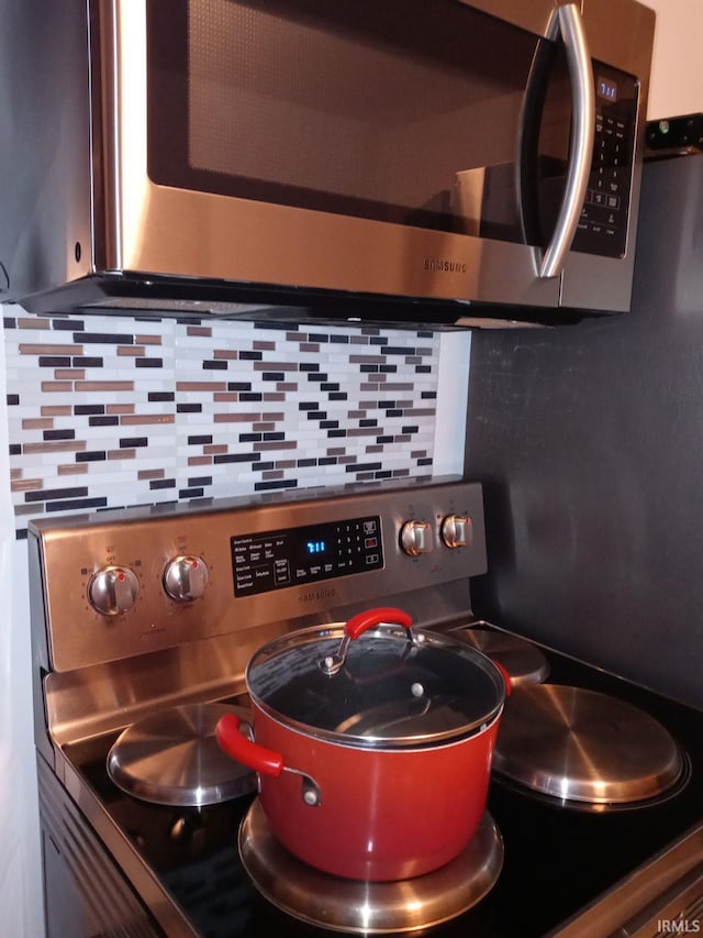 kitchen featuring stainless steel appliances and tasteful backsplash