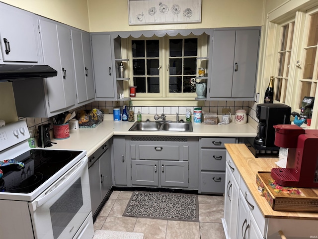 kitchen with sink, tasteful backsplash, gray cabinets, electric stove, and light tile patterned floors