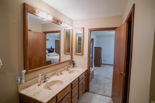 bathroom featuring vanity, a textured ceiling, and tile patterned floors