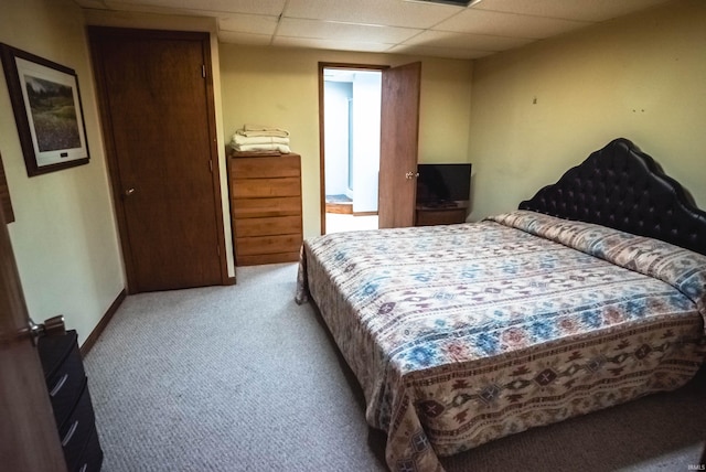 carpeted bedroom featuring a paneled ceiling