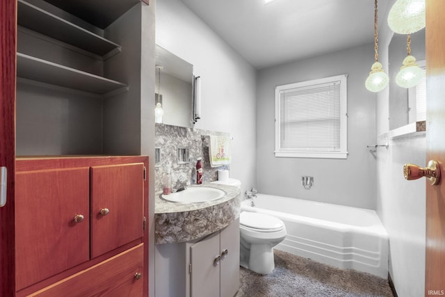 bathroom with vanity, toilet, and a tub to relax in