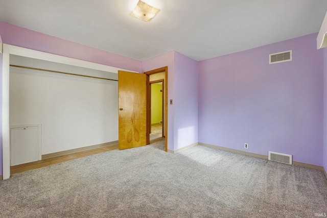 unfurnished bedroom with carpet and a closet