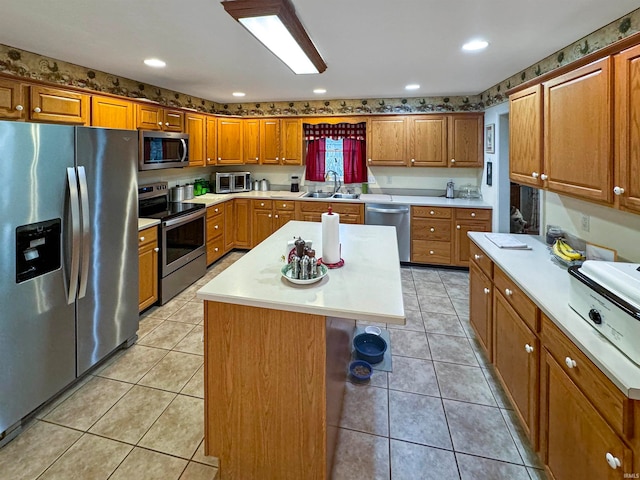 kitchen featuring a center island, light tile patterned floors, sink, and appliances with stainless steel finishes