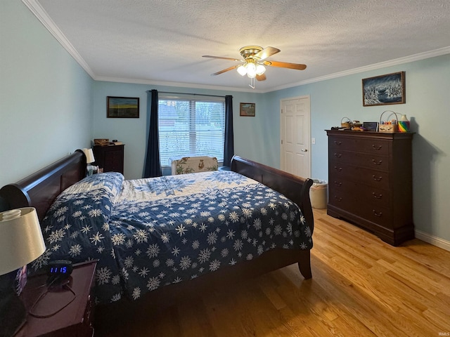 bedroom featuring ceiling fan, light hardwood / wood-style flooring, crown molding, and a textured ceiling