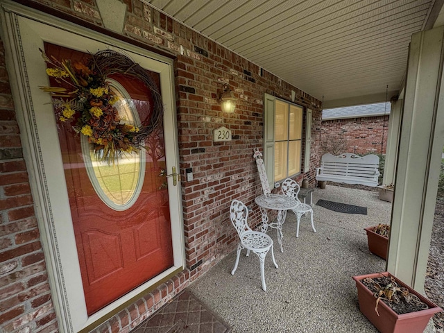 view of exterior entry featuring covered porch