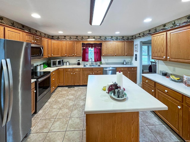 kitchen with a center island, sink, stainless steel appliances, and light tile patterned flooring