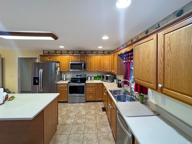 kitchen featuring sink, light tile patterned floors, and stainless steel appliances