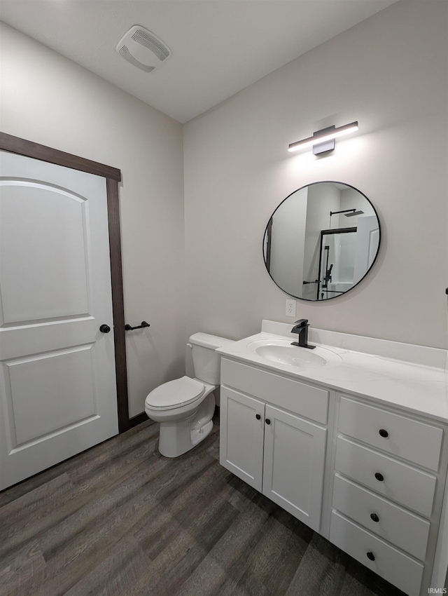 bathroom with vanity, hardwood / wood-style flooring, and toilet