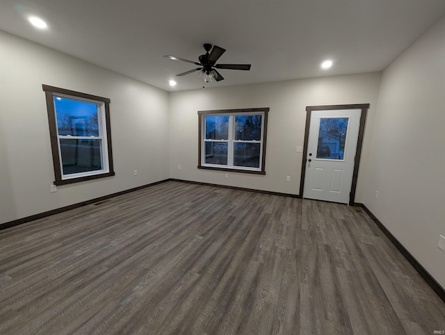 interior space featuring ceiling fan and dark hardwood / wood-style floors