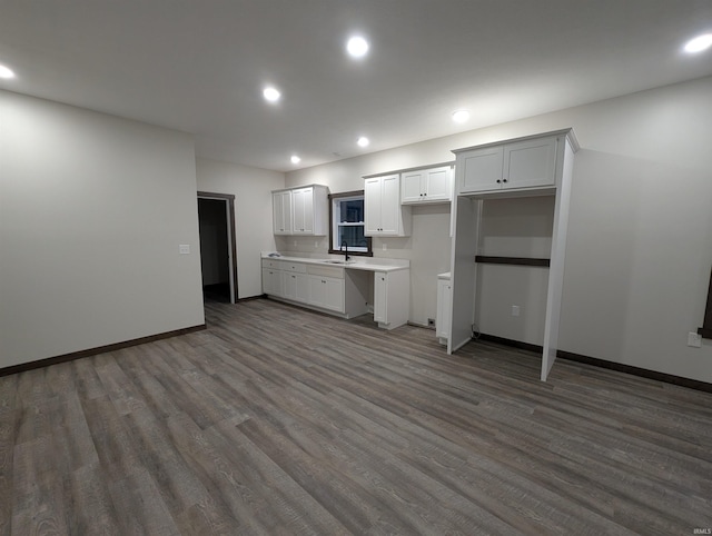 kitchen with white cabinets, dark hardwood / wood-style floors, and sink