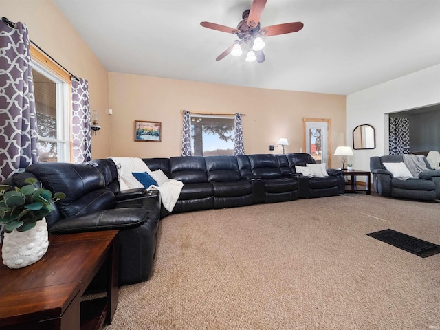 carpeted living room featuring ceiling fan and a healthy amount of sunlight